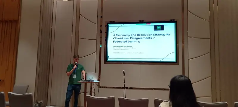 Presenting the paper on stage in Macao, with its title on the screen behind me